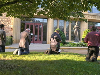 Mourners visit a memorial set up for victims of the mass school shooting at a Catholic school church.