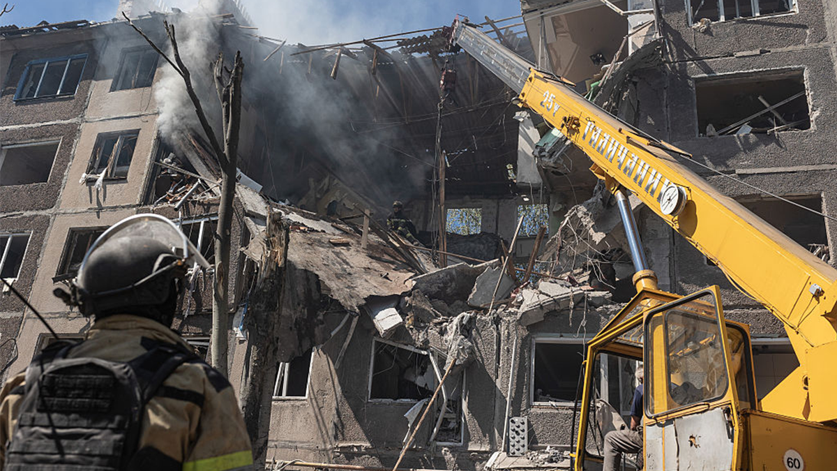 Ukrainian firefighters search for survivors after a Russian air strike