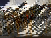 Portland police accuse federal troops of inflaming anti-ICE protests, which city claims have not been violent Federal agents outside ICE facility in Portland, Oregon.